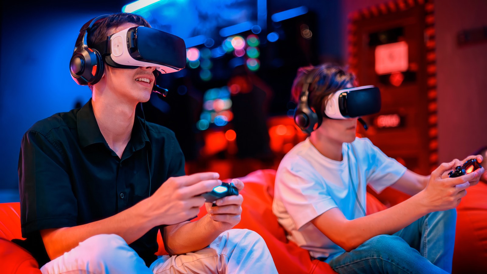 Two players in VR headsets with controllers in a neon-lit lounge.